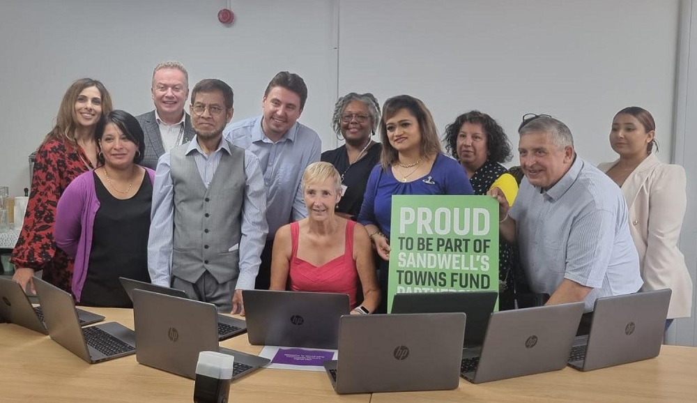 A group of people who attended the digital den opening event