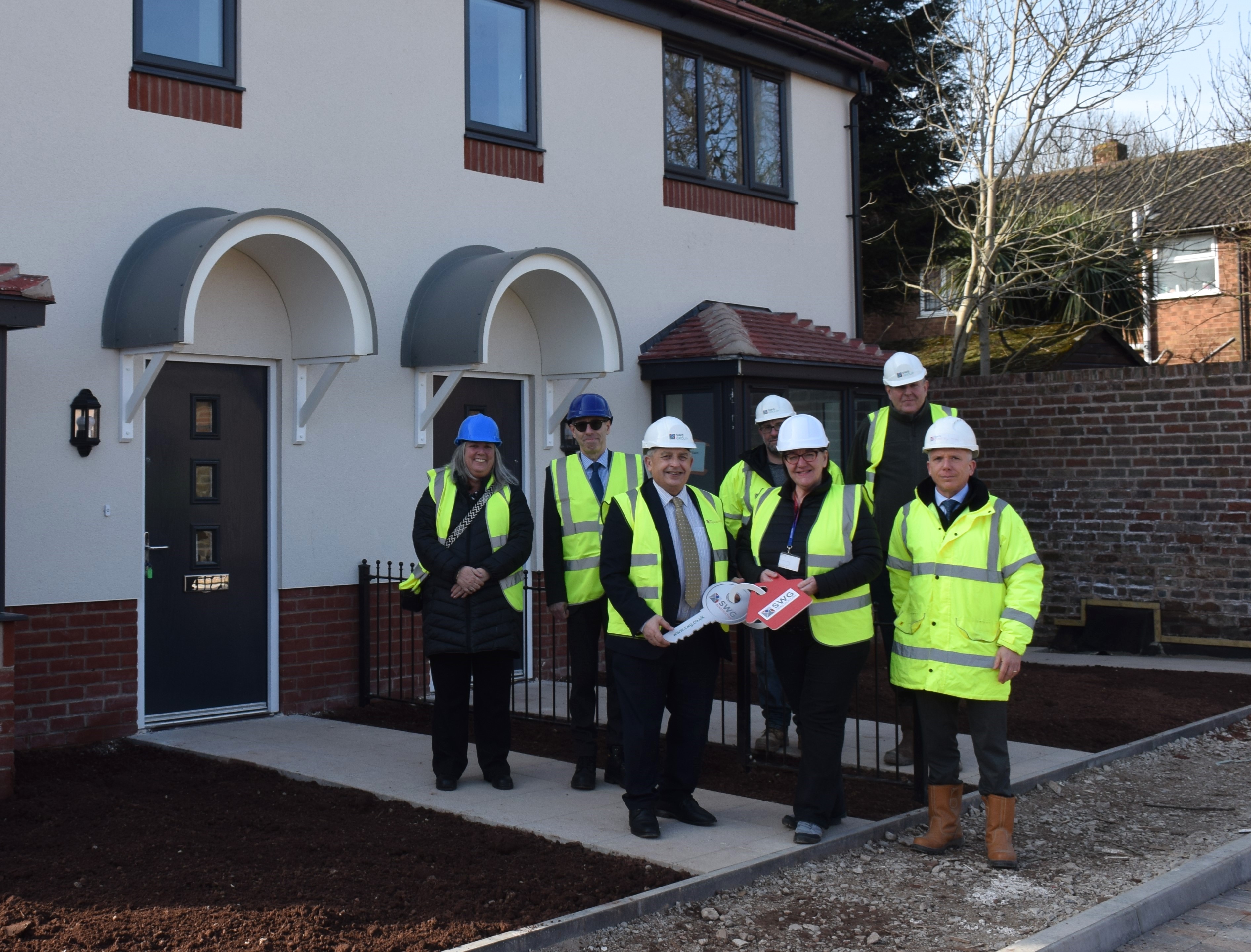 council colleagues and councillors standing in front of the new homes at Whitgreave Street