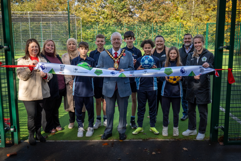 Dignitaries and young people cut ribbon at entrance of the West Smethwick Park&#039;s Play Zone